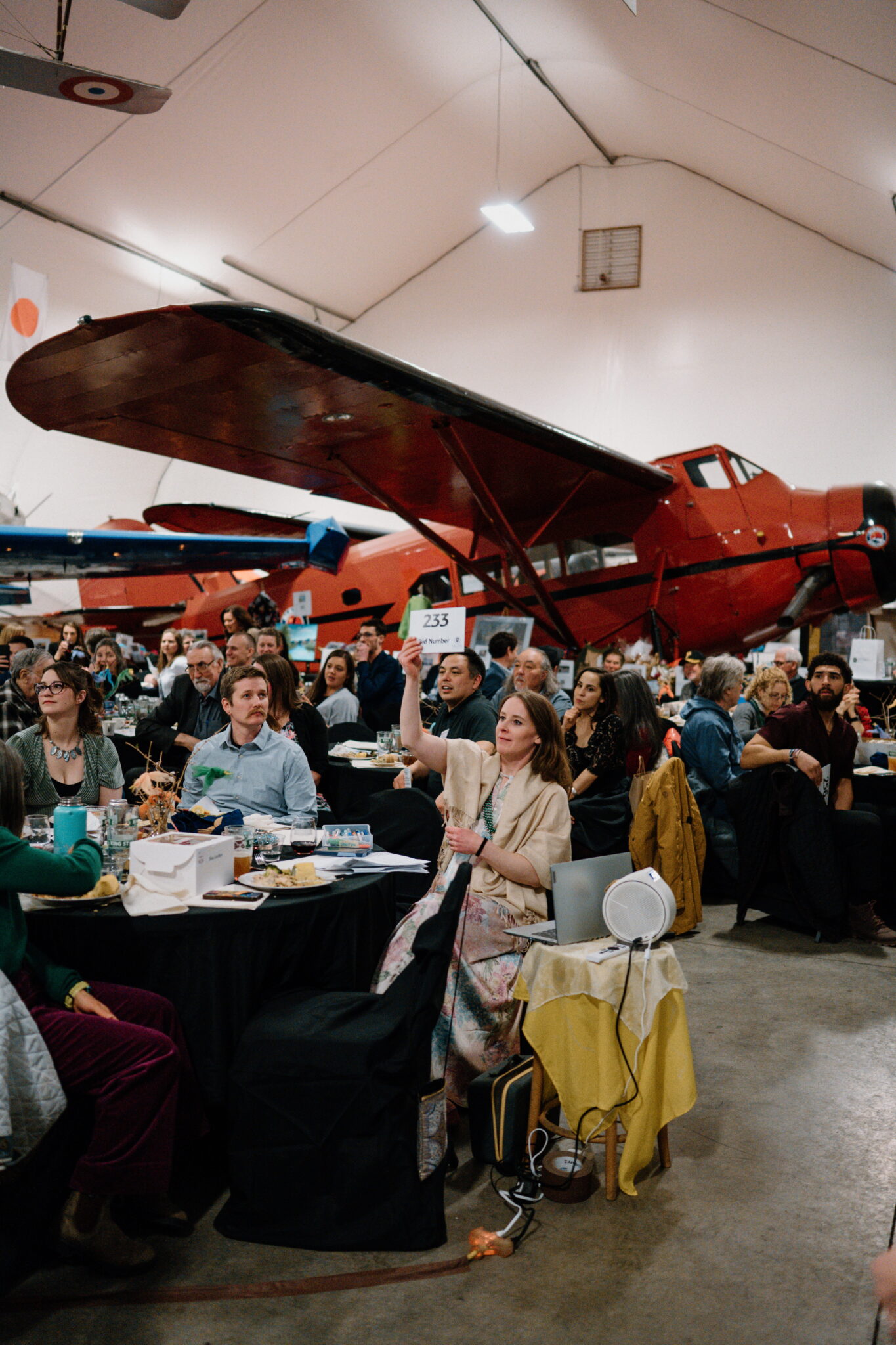 a woman bidding on an item at the spring gala