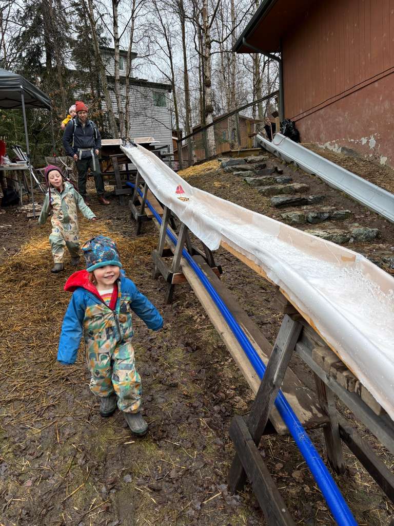 students racing boats down a water track at the anchorage waldorf may faire